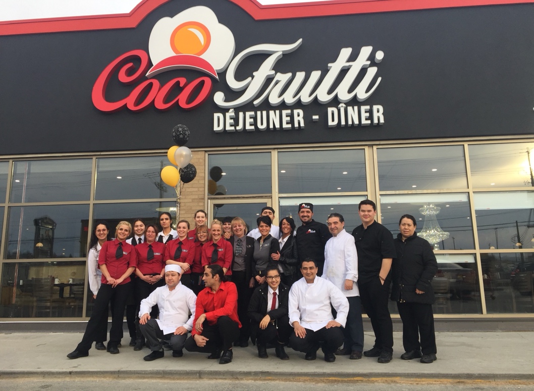 James Noor Akbari and Habib Akbari in chef coats with the Coco Frutti team outside a restaurant