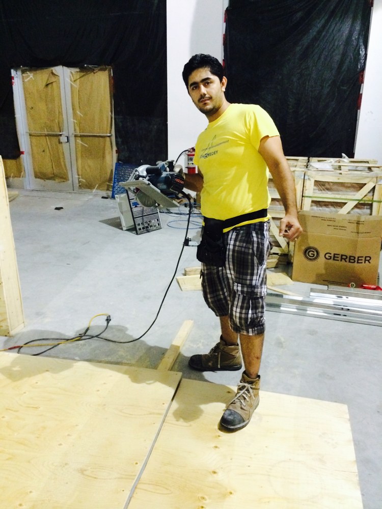 Habib Akbari working on a construction site with his own tools